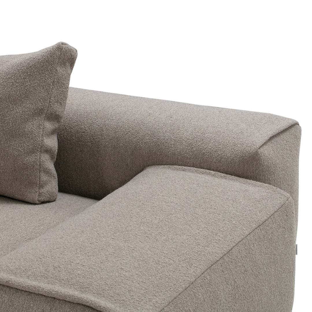 Light taupe fabric sofa with a textured, soft finish and a matching cushion, perfect for modern living spaces.