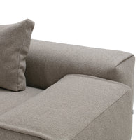 Light beige textured fabric sofa with a simple, modern design, featuring a square arm and soft cushion.