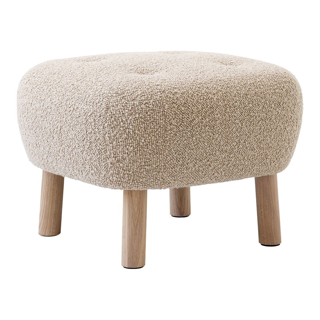 Beige tufted pouf with soft, textured fabric and natural wood legs, perfect for adding warmth to any space.