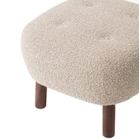 Beige, textured pouf with subtle tufting and dark wooden legs. Perfect for cozy minimalist decor.