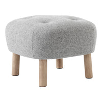 Gray tufted ottoman with a soft fabric finish and natural wooden legs. Round shape complements modern decor.