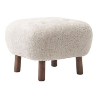 Soft cream-colored ottoman with a textured, fluffy surface and wooden legs, featuring a round, padded design.