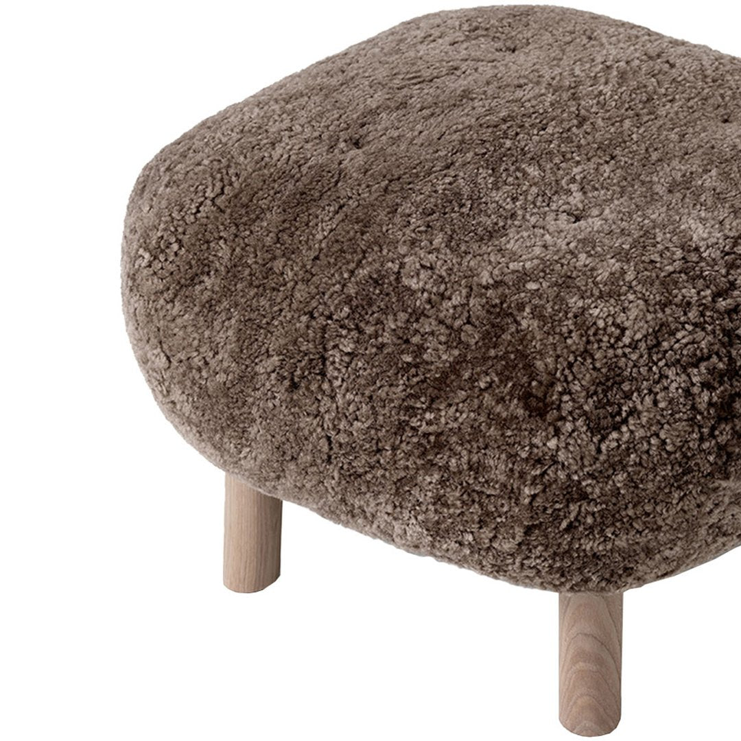Brown plush ottoman with a soft, shaggy texture and natural wood legs. Perfect for cozy, modern decor.