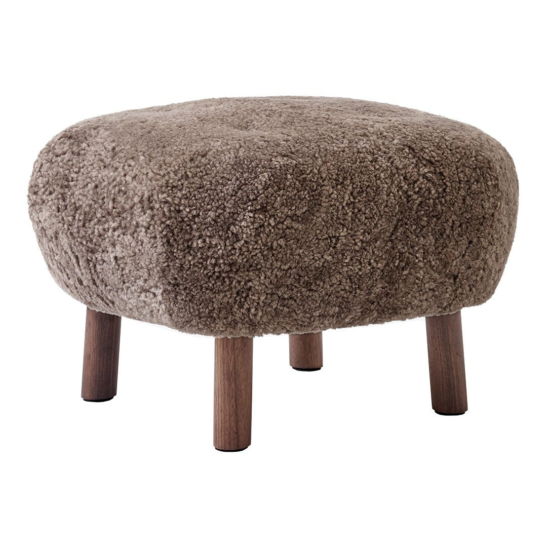 Brown fluffy ottoman with rounded shape and wooden legs, showcasing a cozy, textured surface.