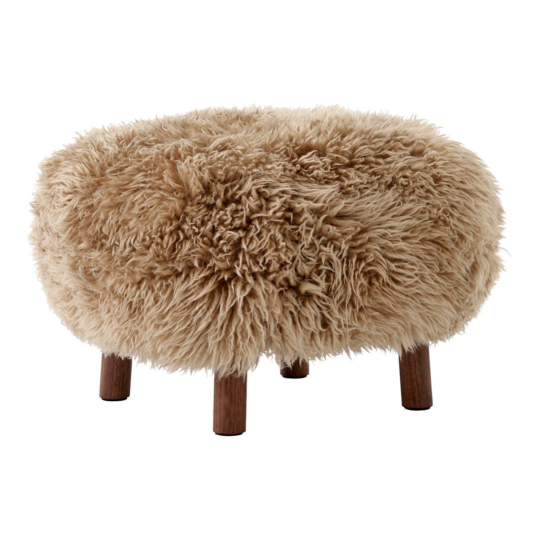 Round, fluffy ottoman in warm beige with a textured, shaggy pattern and wooden legs. Perfect for cozy interiors.