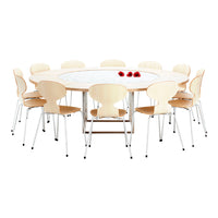 Round wooden table with light wood finish and white marble top, paired with beech wood chairs and red flower accents.
