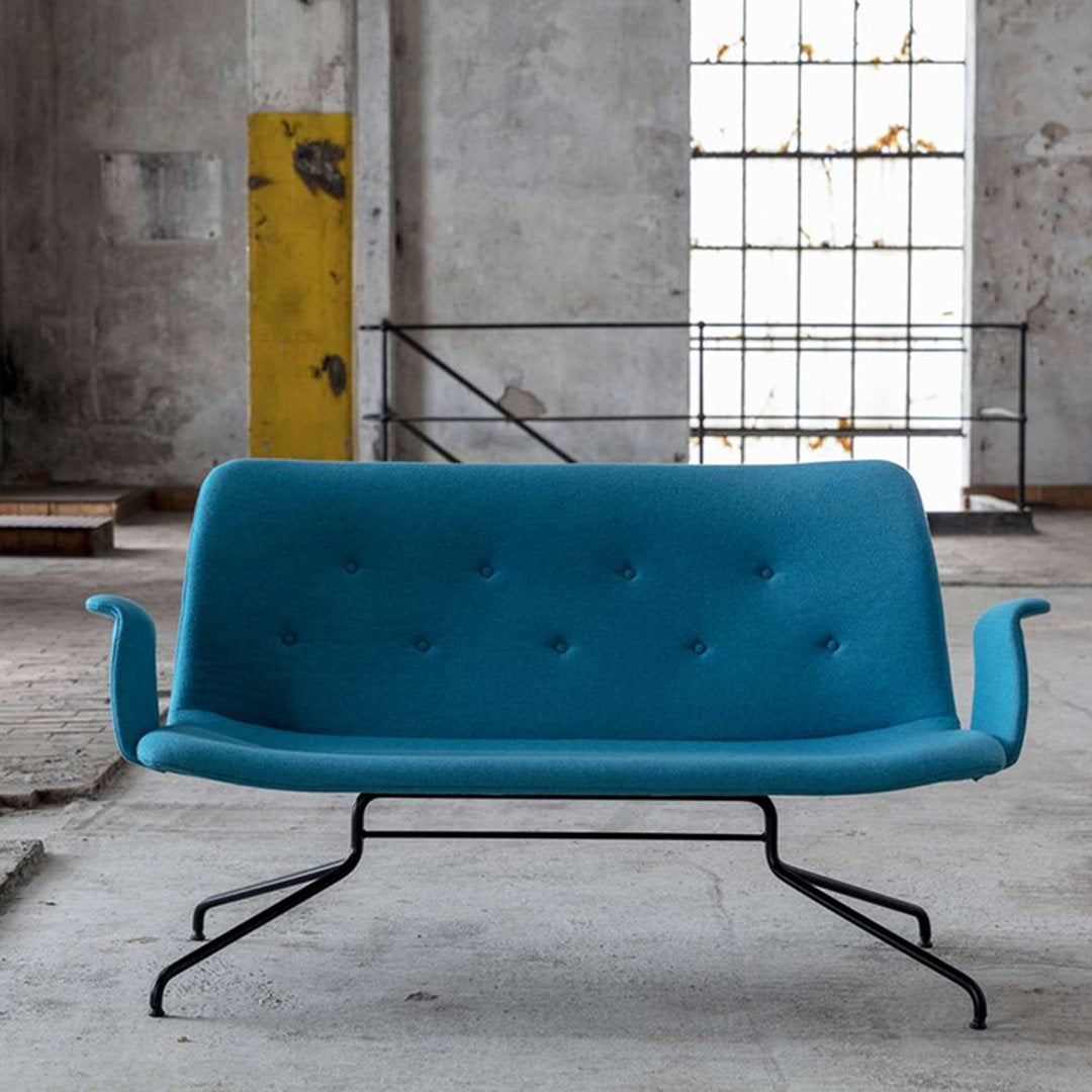 Modern turquoise sofa with button tufting and sleek black metal legs, ideal for contemporary interiors.