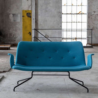 Modern turquoise sofa with button tufting and sleek black metal legs, ideal for contemporary interiors.