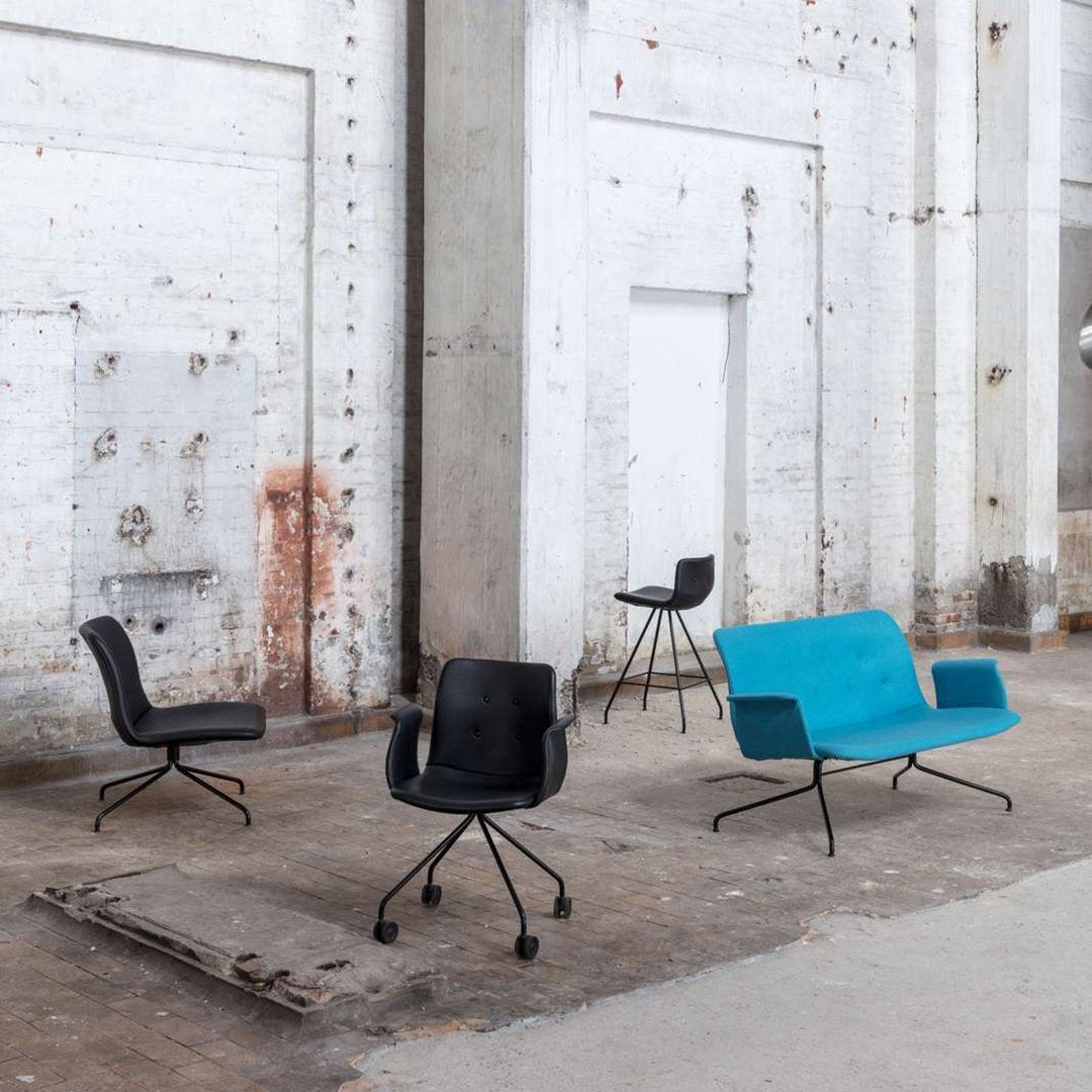 "Set of four chairs featuring sleek black and vibrant turquoise colors with modern, minimalist designs."