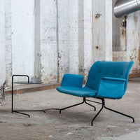 Teal upholstered chair with a modern design and subtle tufted pattern, complemented by a sleek black metal frame.