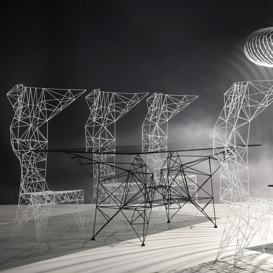 "Modern wireframe furniture in sleek black and white, featuring geometric patterns and intricate designs."