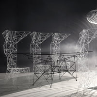 "Modern wireframe furniture in sleek black and white, featuring geometric patterns and intricate designs."
