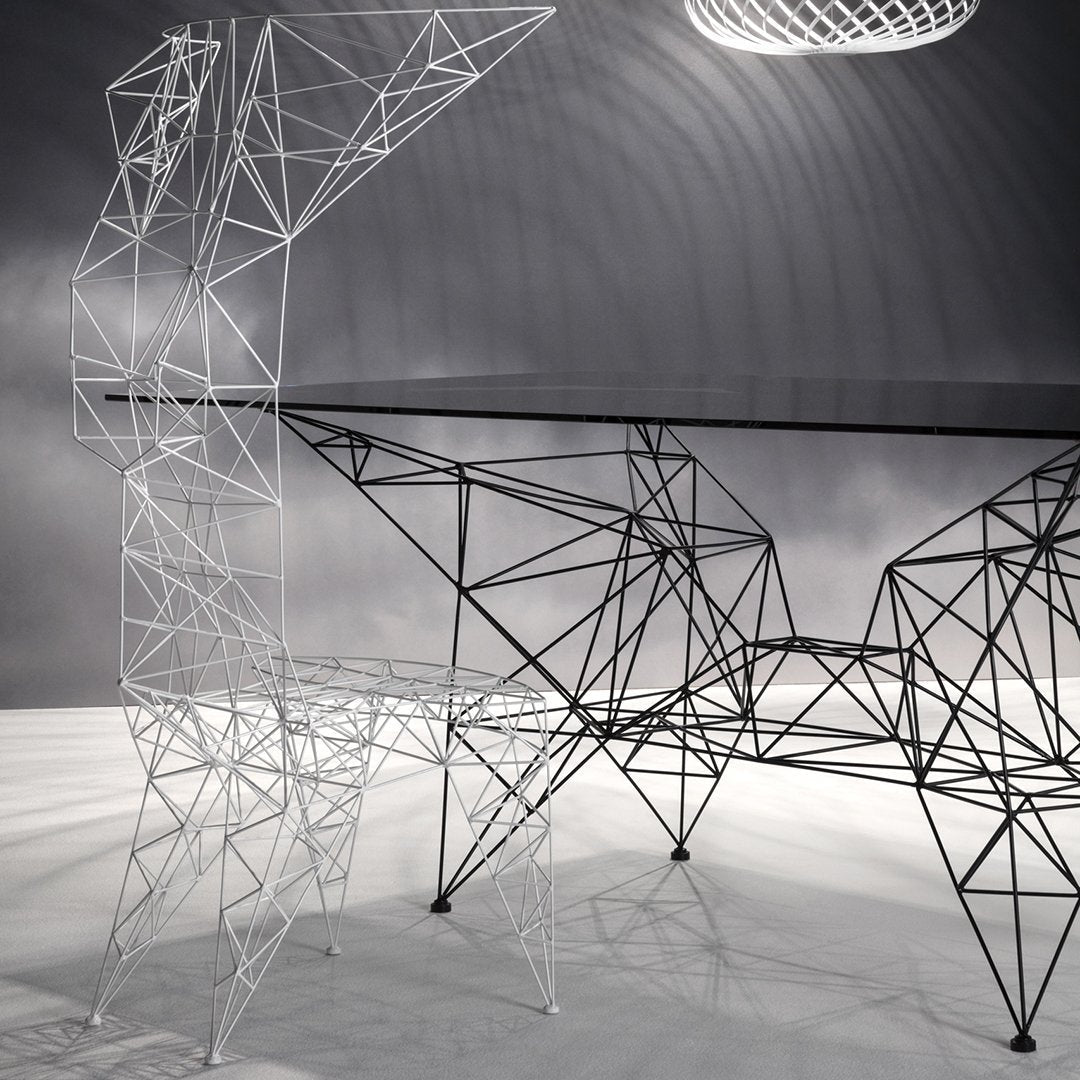 Sleek black and white geometric desk with intricate wireframe design and modern minimalist aesthetics.