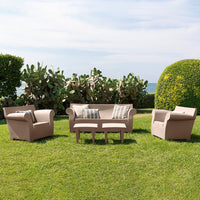 Beige outdoor seating set with striped accent cushions, featuring geometric patterns, on a lush green lawn.