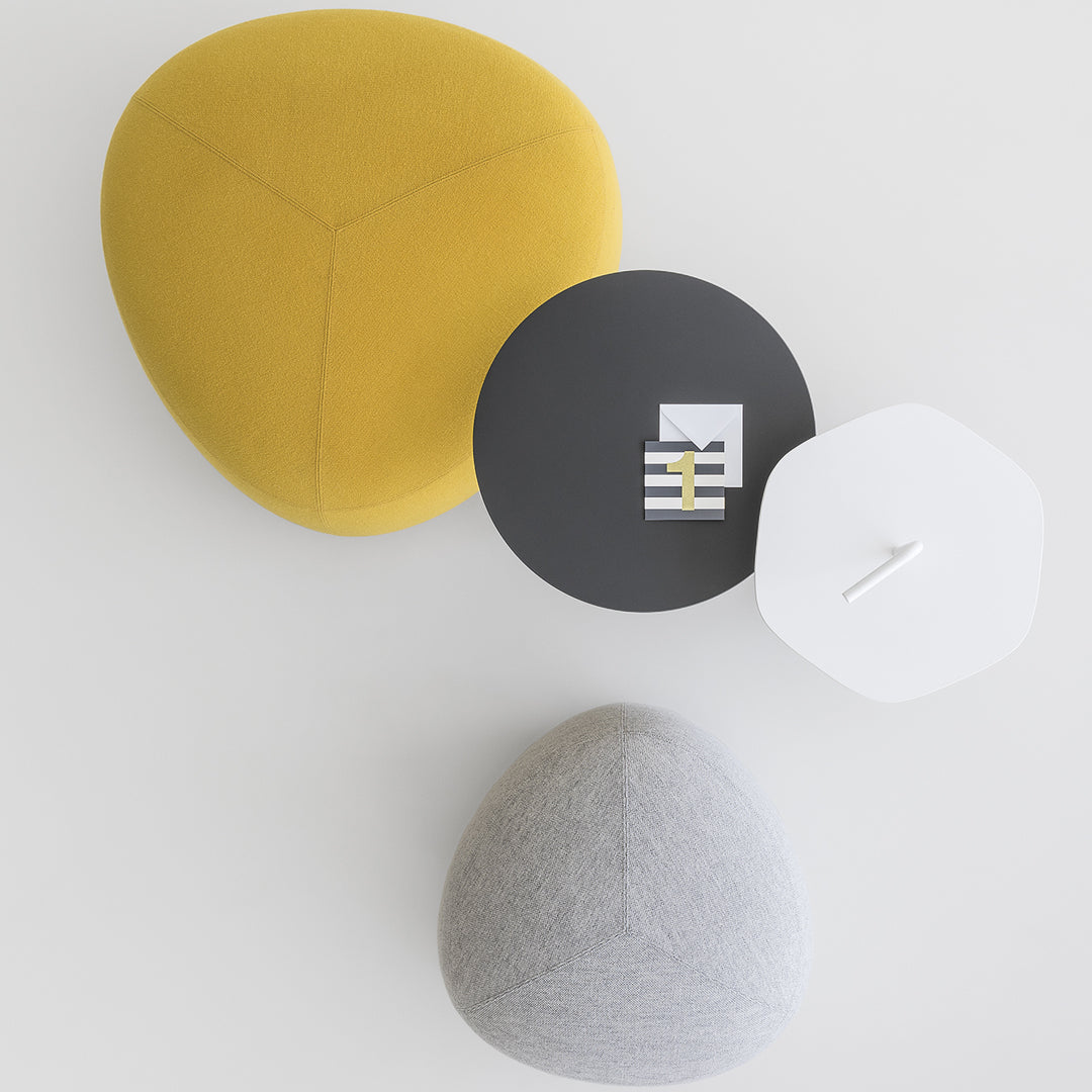 Colorful geometric cushions in yellow, gray, and black, featuring modern design and soft textures.