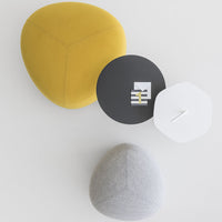 Colorful geometric cushions in yellow, gray, and black, featuring modern design and soft textures.