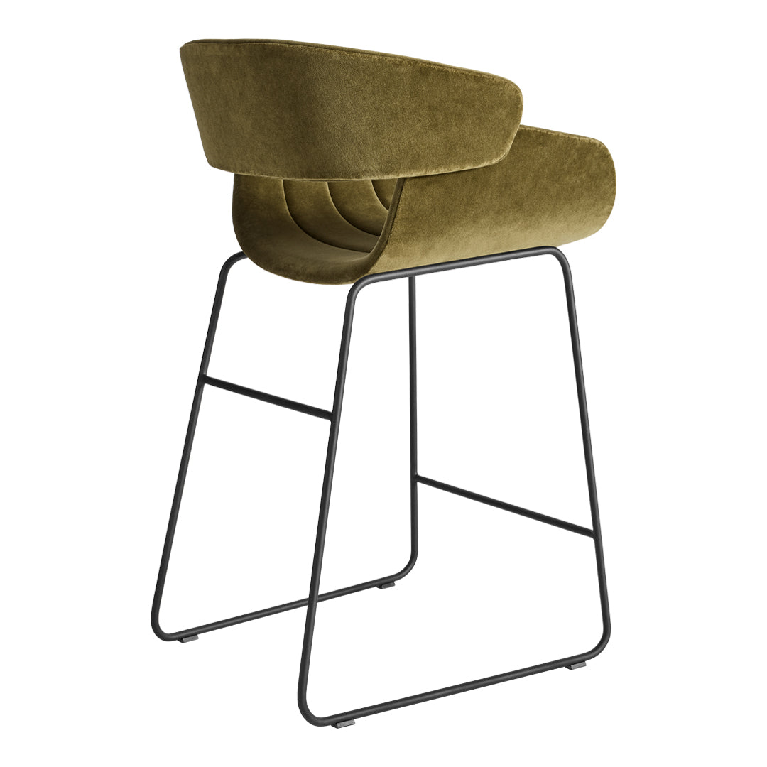 Olive green velvet bar stool with a sleek black metal frame, featuring a modern curved design.