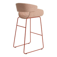 Blush pink upholstered bar stool with a sleek red metal frame, featuring a smooth, curved design.