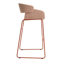 Peach upholstered bar chair with a modern orange metal frame. Sleek and stylish for any contemporary space.