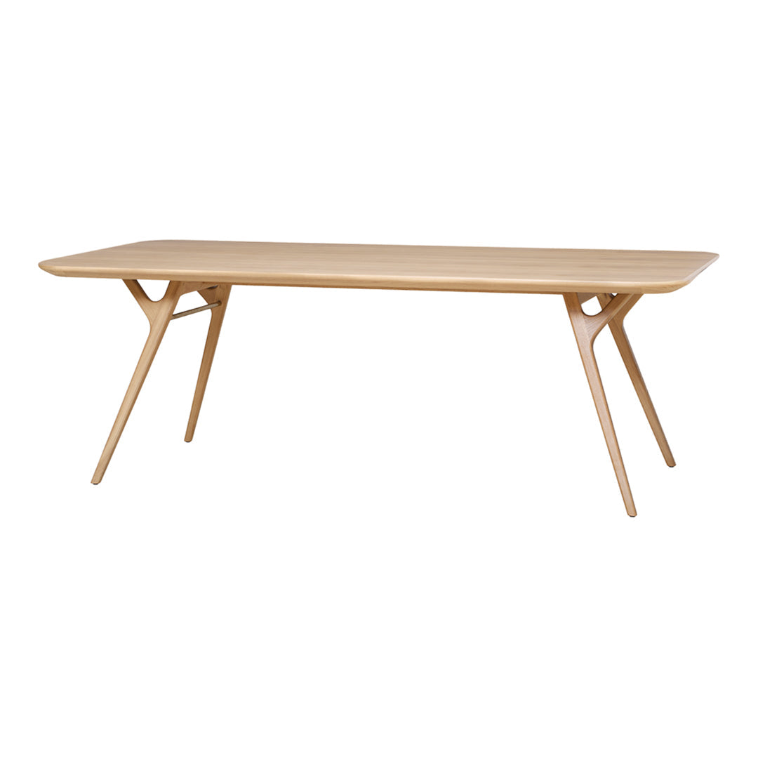 Light wood dining table with a smooth, natural finish and minimalist design, featuring clean lines and no patterns.