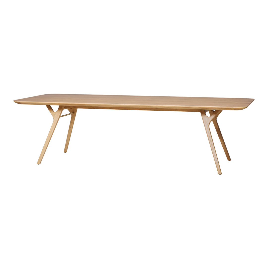 Light oak rectangular dining table with smooth surface and angled legs, showcasing a natural wood finish.