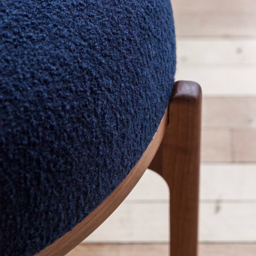 Navy blue textured upholstery with a smooth wooden frame, showcasing modern design and rich colors.