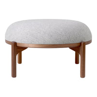 Light gray upholstered ottoman with a smooth, rounded top and dark wood legs, featuring a minimalist design.