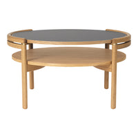 Elegant round coffee table with a black top and natural oak wood base, showcasing a minimalist design.