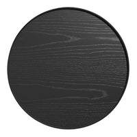 Round black wood table with a sleek, grainy texture, featuring a modern minimalist design. Perfect for contemporary decor.
