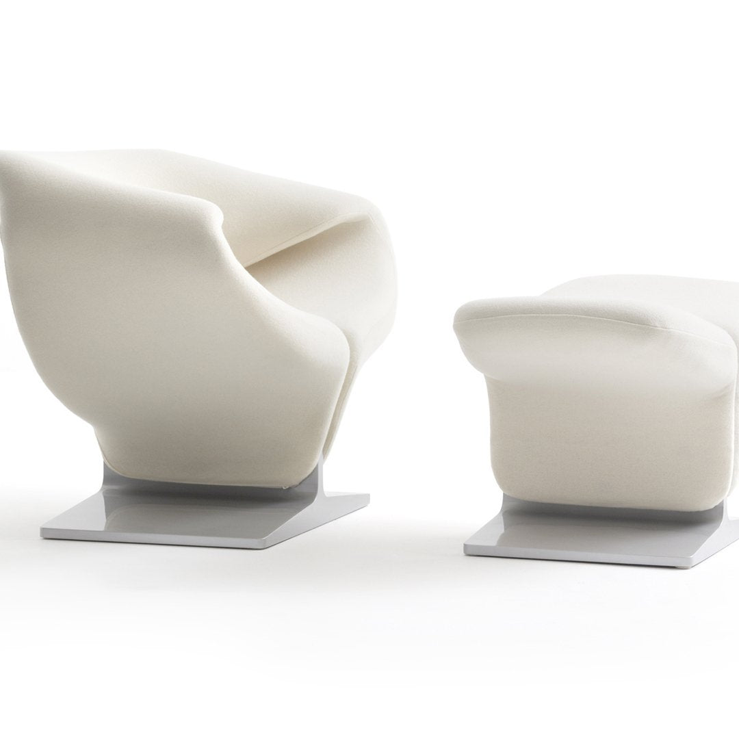 Modern white armchair and ottoman set with sleek gray bases, featuring a smooth, curved design. Ideal for contemporary spaces.