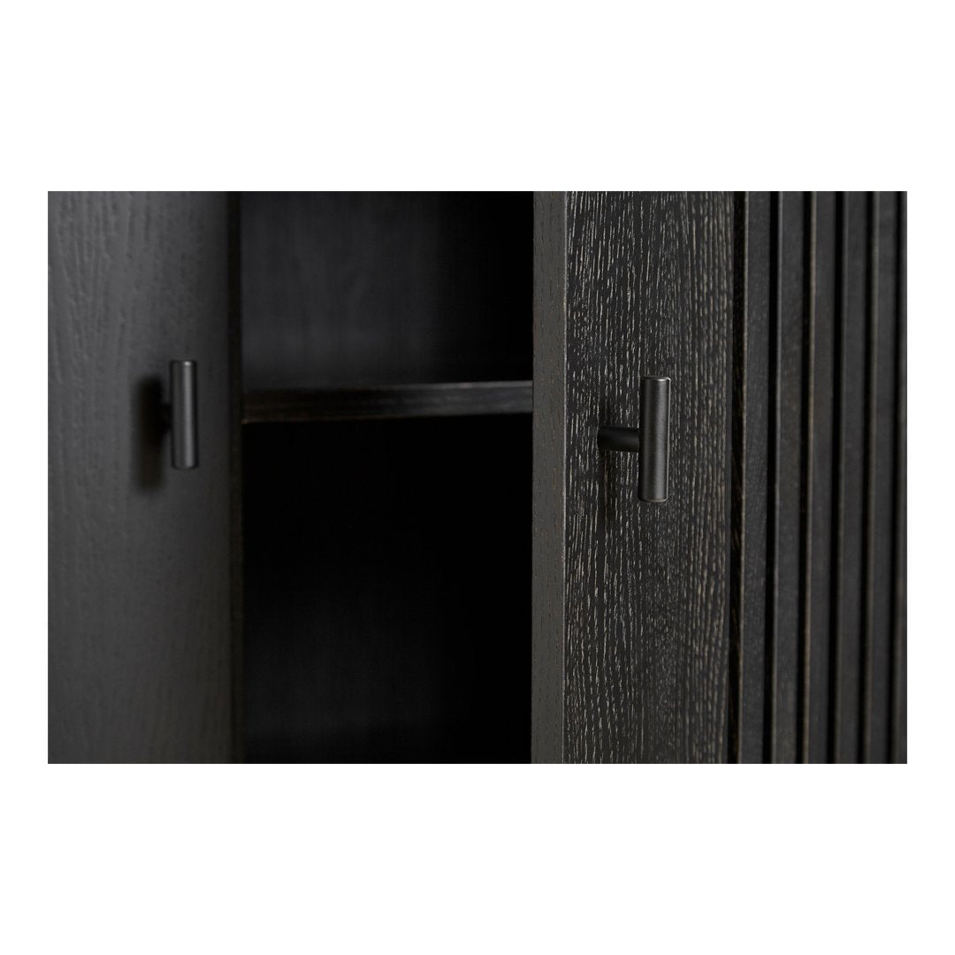 Black wood cabinet with sleek vertical grooves and minimalist black handles, showcasing a modern, textured design.