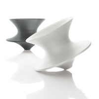 "Two sculptural vases in matte black and white, featuring a smooth, swirling pattern for modern decor accents."