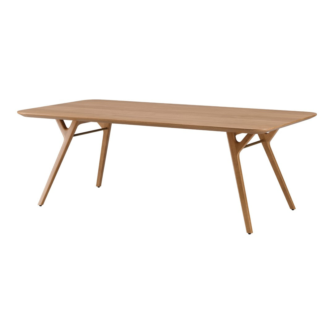 Light oak dining table with a smooth surface and sleek, minimalist design. Natural wood finish enhances modern decor.