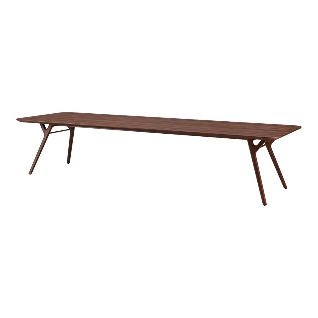 Modern rectangular walnut wood table with sleek lines and a warm brown finish, showcasing natural grain patterns.