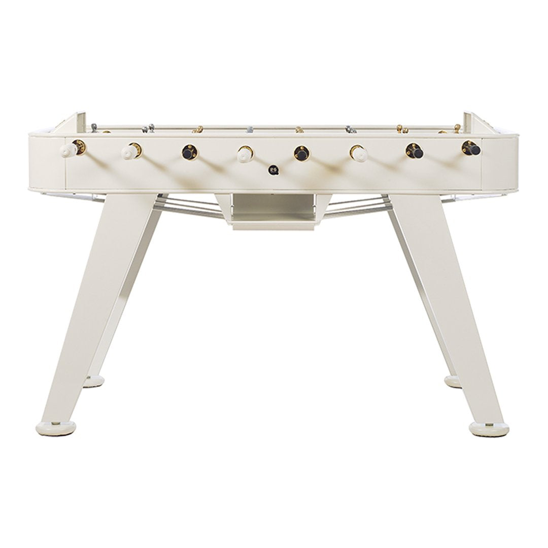 White foosball table with sleek design and gold accents on knobs, offering a modern and minimalist look.