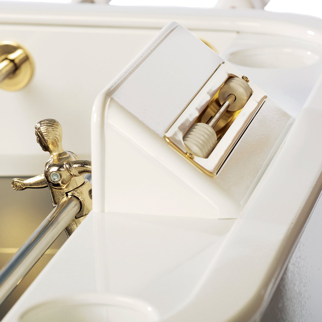 White and gold mini golf putting green with glossy finish and sleek patterns, featuring a golden figure affixed on a white base.