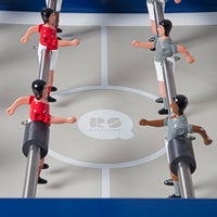 Red and gray foosball players on a light gray pitch with a blue frame and white markings, featuring a logo at center.
