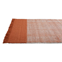 Rust orange and soft beige patterned rug with fringed edges, ideal for adding warmth to any space.