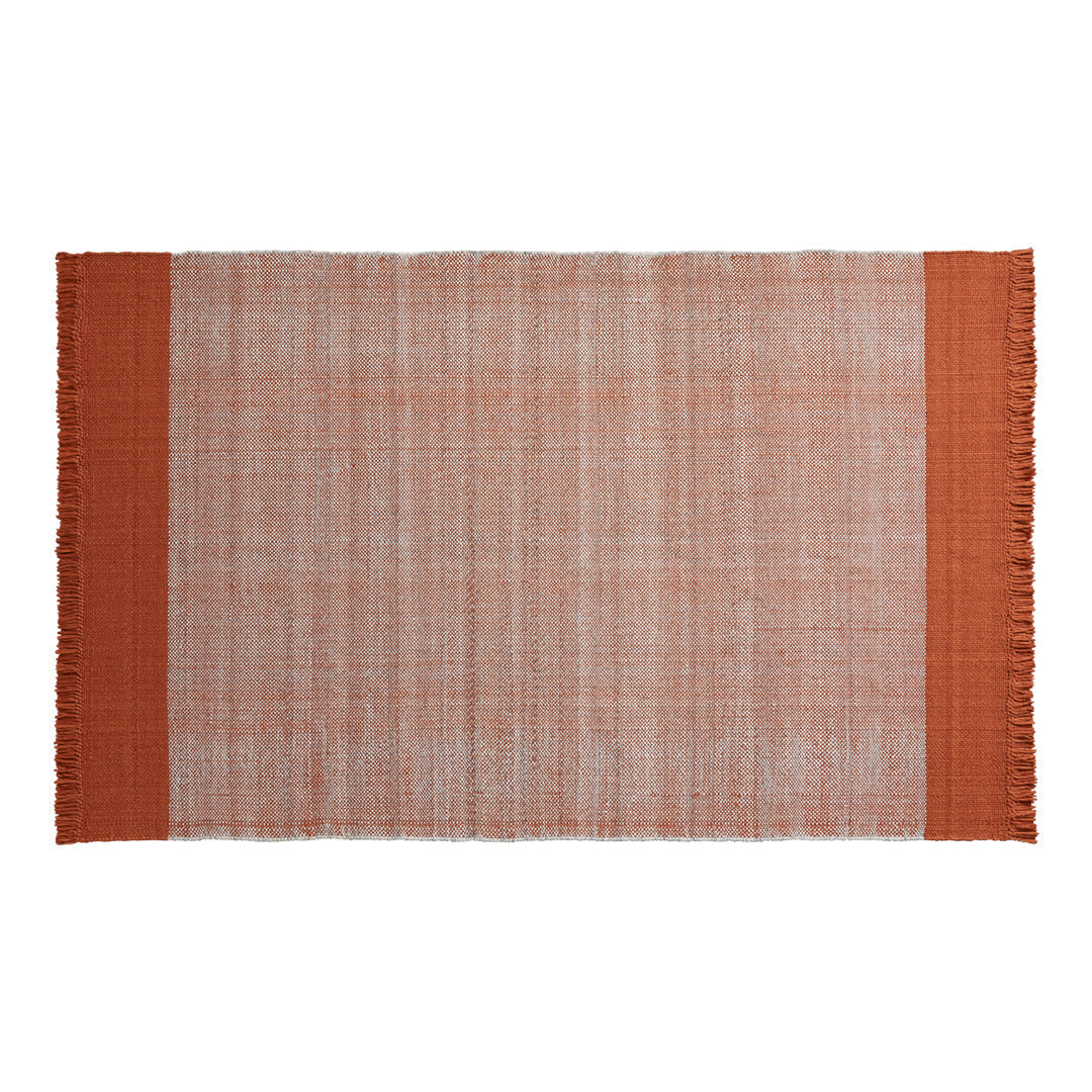 Rust-colored fringed rug with a textured, light orange background and solid dark orange borders.