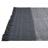 "Soft gray and dark navy striped rug with fringed edges, perfect for modern decor."
