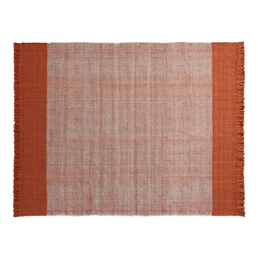 Terra cotta and muted beige woven rug with fringed edges, featuring a simple, textured design.