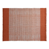 Terra cotta and muted beige woven rug with fringed edges, featuring a simple, textured design.