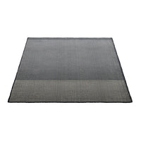 "Square rug featuring sleek gray tones with a textured pattern and a subtle lighter section at the bottom."