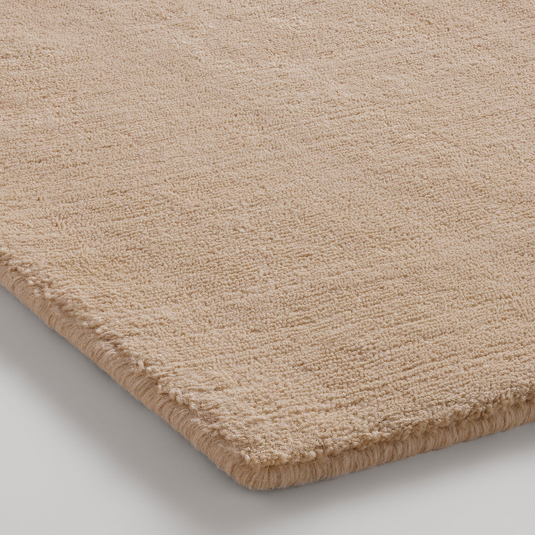 Beige textured rug with a soft, plush finish, ideal for adding warmth and sophistication to any space.