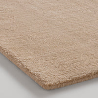 Beige textured rug with a soft, plush finish, ideal for adding warmth and sophistication to any space.