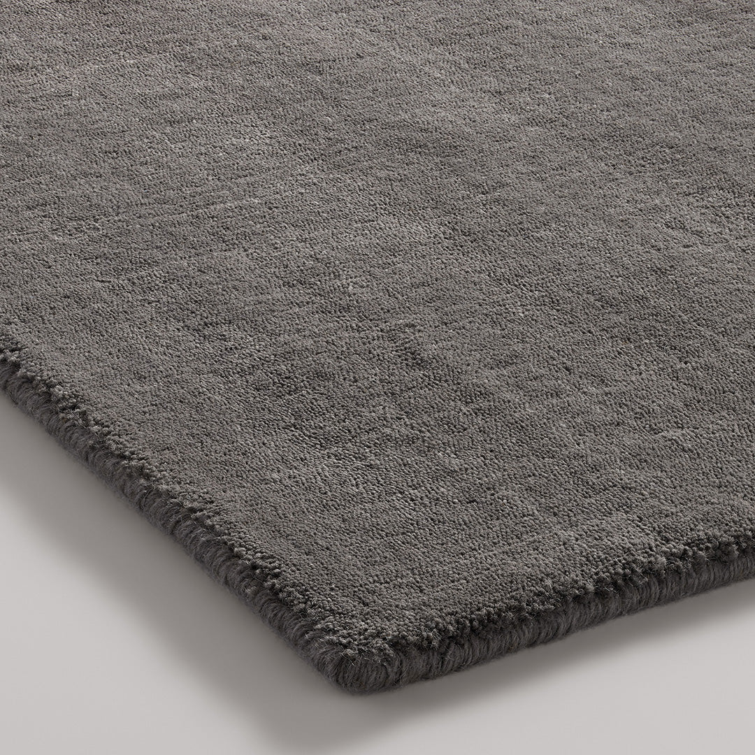 Soft gray shag rug with a rich texture and subtle sheen, perfect for adding warmth to any space.
