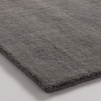 Soft gray shag rug with a rich texture and subtle sheen, perfect for adding warmth to any space.