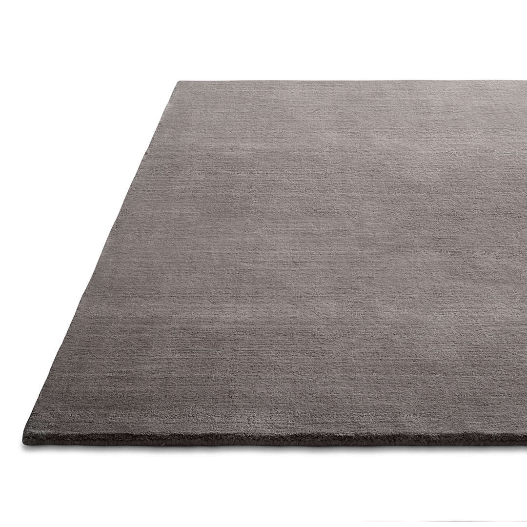 Gray textured area rug with a subtle woven pattern, perfect for modern interior decor.