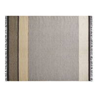 Neutral-toned blanket with striped pattern in gray, beige, and black; features fringed edges for added texture.