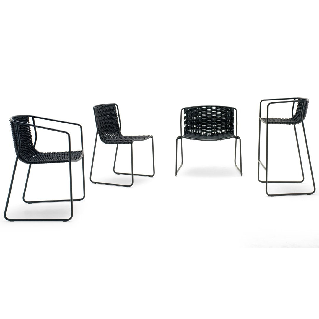 Black woven chairs with sleek metal frames, showcasing a modern minimalist design and varied seating heights.